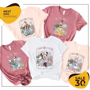 a collection of Disney World merchandise, including t-shirts and shirts featuring various Disney characters such as Minnie Mouse, Donald Duck, and Mickey Mouse.