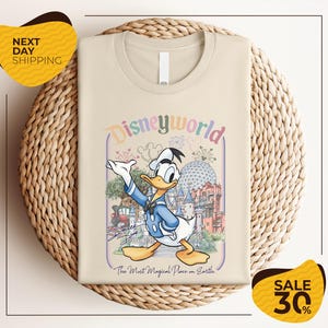 A t-shirt featuring a cartoon image of Disney's iconic character, Donald Duck, with a colorful and whimsical design.