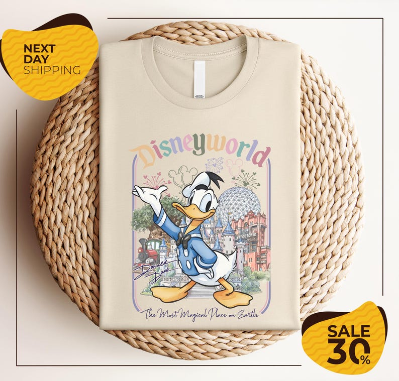 A t-shirt featuring a cartoon image of Disney's iconic character, Donald Duck, with a colorful and whimsical design.