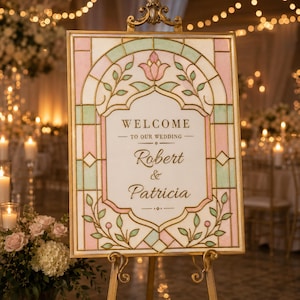 Puede incluir: Un cartel de bienvenida de boda rectangular con un borde estilo vidriera en rosa pastel y verde claro. El panel central blanco tiene el texto dorado WELCOME TO OUR WEDDING Robert & Patricia, sobre un soporte de metal dorado.