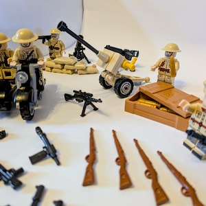 May include: A selection of toy soldiers, weapons, and vehicles. Includes miniature figures, a motorcycle, a cannon, rifles, and a box of ammunition. The figures wear tan uniforms and helmets. The set is designed for play and display.