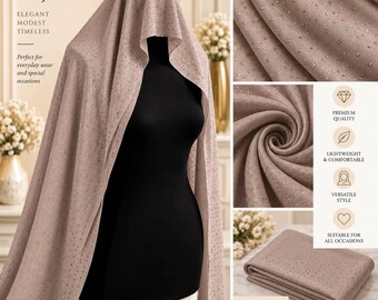 May include: A dusty rose hijab featuring a subtle shimmer and scattered rhinestone embellishments. The fabric is draped over a black mannequin, showing a soft texture and a folded stack of the same material with detailed close-up views.
