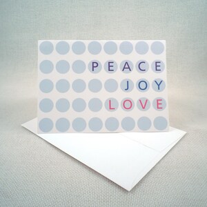 Tarjeta de felicitación con un punto de Polk y la frase "Difunde paz, alegría y amor"
