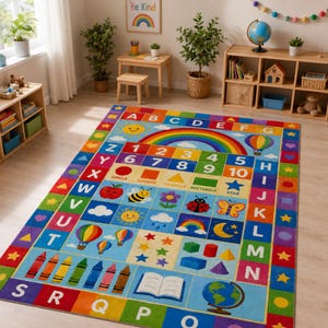 May include: A rectangular educational area rug featuring a colorful alphabet border, a central rainbow, numbers one through ten, geometric shapes, and various illustrations including a globe, crayons, an apple, a bee, and a ladybug.