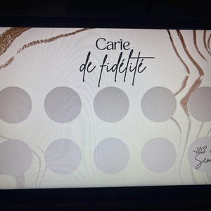 May include: A loyalty card with a light beige background and gold abstract design. The card features the text "Carie de fid&eacute;lit&eacute;" in black script, along with eight gray circles and the text "-20% ou Semi".