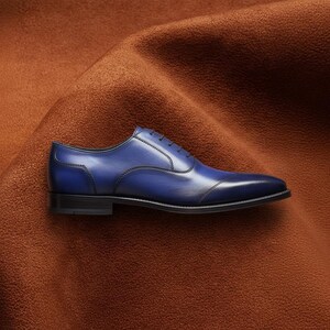 Veronatti handmade men's navy blue leather cap toe Oxford dress shoes, hand-burnished patina finish, side profile view on rust suede background