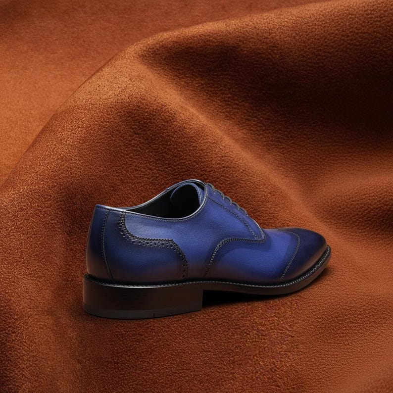 Rear three-quarter view of Veronatti navy blue leather Oxford shoes showing heel construction, brogue perforated detailing, and leather sole