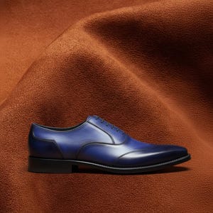 Close-up of hand-burnished navy blue patina on Veronatti calf leather Oxford dress shoe upper showing depth and tonal variation