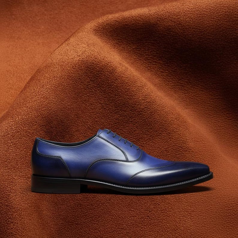 Close-up of hand-burnished navy blue patina on Veronatti calf leather Oxford dress shoe upper showing depth and tonal variation