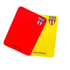 May include: A red and yellow rectangular card set. The red card has the text "Kevin Rodrigo" in cursive at the bottom and a "RWISOA" logo in the upper right corner. The yellow card has the same text and logo.
