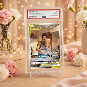 May include: A graded Pok&eacute;mon card in a clear plastic case. The card features an illustration of a man and woman in a kitchen, with the text "Marco & Rosa GX" and "Home Kitchen Love". The card is displayed on a clear stand.