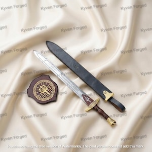 May include: A metal sword with an etched blade, a dark wooden handle, and a gold-toned pommel and crossguard. It includes a black leather scabbard with gold-toned accents and a small, circular wooden plaque featuring a gold trident emblem.