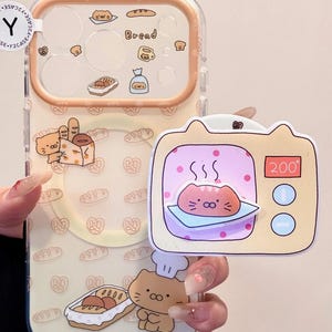 May include: Clear phone case with a bread-themed design. The case features illustrations of bread, pretzels, and a cat chef. A separate cat-shaped microwave sticker is included, with a cat inside.