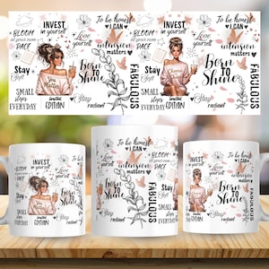 May include: White ceramic coffee mugs with a motivational design. The design includes illustrations of a woman, flowers, and text such as "Born to Shine" and "Invest in Yourself". The mugs are on a wooden surface.