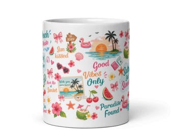 May include: A white ceramic mug featuring a colorful pattern of summer-themed illustrations including palm trees, flamingos, watermelons, hibiscus flowers, and bows. The text reads "Sun kissed," "Good Vibes Only," "Meet Me at Sunset," and "Paradise Found."