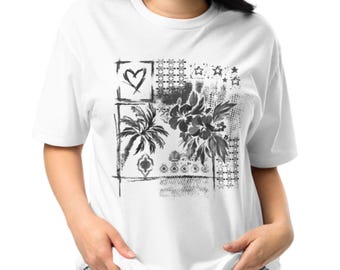 May include: A white short-sleeved t-shirt featuring a black graphic print on the front. The design includes a heart, a palm tree, hibiscus flowers, and various geometric patterns arranged in a square composition with a distressed texture.