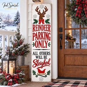 Puede incluir: Un letrero de madera blanco, alto y rectangular, con acabado desgastado, que presenta una cabeza de reno marrón, un lazo rojo y texto en rojo y negro que dice: REINDEER PARKING ONLY ALL OTHERS WILL BE SLEIGHED, con ramas verdes y copos de nieve.