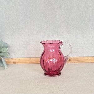 Vintage Small Cranberry or Ruby Pink Glass Pitcher Creamer With Clear Handle And Scalloped Rim