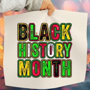 May include: A white poster with the words "BLACK HISTORY MONTH" in large, colorful letters. The text is outlined in black and filled with green, yellow, and red. The letters have decorative patterns.
