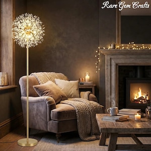 May include: A gold floor lamp with a crystal dandelion-shaped shade illuminates a cozy living room. The lamp stands next to a brown armchair with pillows and a blanket. The room features a fireplace and wooden furniture.