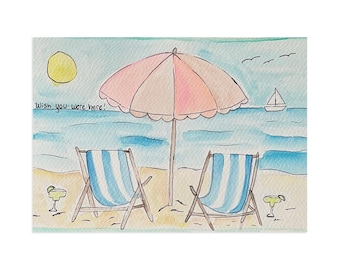 May include: A watercolor illustration of a beach scene featuring two blue and white striped lounge chairs under a large pink umbrella. The text "Wish you were here!" is written on the left. A yellow sun, a sailboat, and two cocktails are visible.