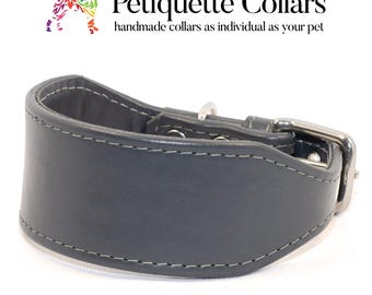 May include: A dark gray leather dog collar with a silver buckle and stitching. "Petiquette Collars" is written in white text on a white background above the collar. The text below the logo reads "handmade collars as individual as your pet".