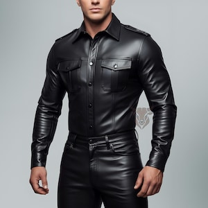 May include: A black long-sleeved shirt with a smooth finish, featuring a pointed collar, button-down front, and two chest pockets with flaps. The shirt includes shoulder epaulets and is paired with matching black pants, creating a cohesive outfit.