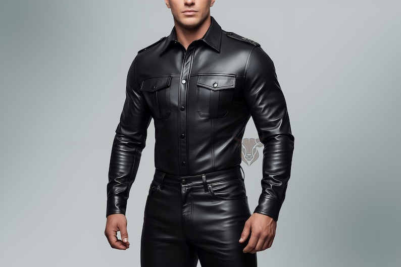 May include: A black long-sleeved shirt with a smooth finish, featuring a pointed collar, button-down front, and two chest pockets with flaps. The shirt includes shoulder epaulets and is paired with matching black pants, creating a cohesive outfit.