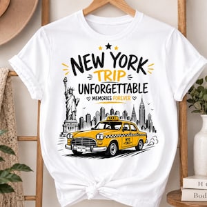 May include: A white short-sleeve t-shirt featuring a graphic print of a yellow New York taxi, the Statue of Liberty, and a city skyline. The text reads NEW YORK TRIP UNFORGETTABLE MEMORIES FOREVER, with NYC TAXI on the car door and license plate.
