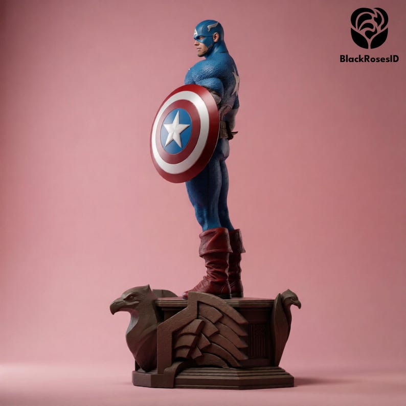 May include: A detailed figurine of Captain America, clad in a blue and red costume, holding his iconic shield. The figure stands on a brown base with eagle-like carvings, set against a pink backdrop. The shield features a white star.