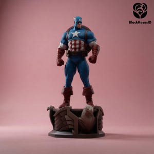 May include: A Captain America figurine stands on a detailed base with an eagle design. The figure is in a classic pose, wearing a blue and white uniform with a star emblem, red gloves, and boots. The background is a solid pink.