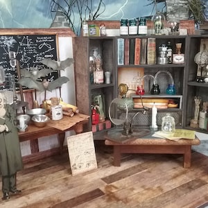 May include: A miniature dollhouse room with a scientist's laboratory theme. The room features a wooden table with a chalkboard, a shelf with various glass bottles and jars, and a small table with a magnifying glass and a candle. There is a small figure of a scientist standing in the room.