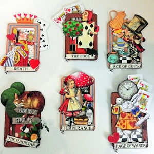 May include: A set of ten illustrated tarot cards featuring characters and scenes from Alice in Wonderland. The cards are decorated with colorful details and include the names "Death", "The Fool", "Ace of Cups", "Temperance", "The Magician", and "Page of Wands".