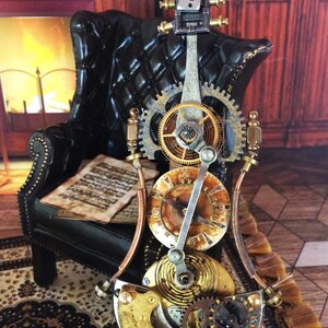 May include: A steampunk-style, clockwork sculpture of a double bass with intricate gears and clock faces. The sculpture is made of metal and has a copper-colored finish. It is sitting on a patterned rug in front of a black leather armchair.