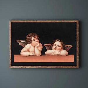 May include: A framed print featuring two cherubic figures with wings, resting their arms on a peach-colored ledge against a black background. The artwork is enclosed in a rustic wooden frame, evoking a classic aesthetic.