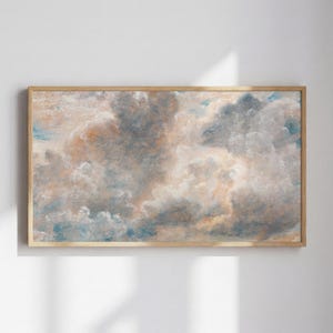 May include: A framed artwork featuring a cloudy sky with shades of blue, gray, and peach. The painting has a textured appearance, with visible brushstrokes. The wooden frame adds a classic touch to the artwork.