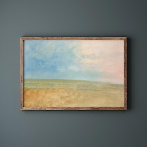 May include: Landscape painting in a rustic wooden frame. The artwork depicts a field of wheat under a blue and pink sky. The painting has a soft, impressionistic style, with muted colors and a sense of calm.