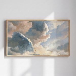 May include: A framed print featuring a classical painting of a cloudy sky. The artwork showcases a blend of blue, peach, and white hues, creating a soft, ethereal atmosphere. The wooden frame adds a touch of warmth to the artwork.
