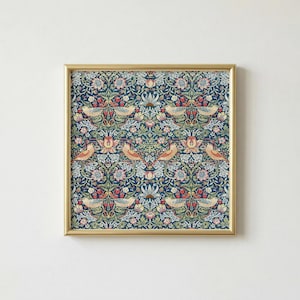 May include: A framed print featuring a repeating pattern of birds, flowers, and foliage in shades of blue, red, and beige. The artwork is enclosed in a gold-colored frame, creating a decorative piece suitable for home decor.