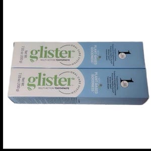 May include: Two tubes of "glister" multi-action toothpaste. The packaging is white and light blue, with the brand name in green. Each tube contains 7.05 oz (200 g) of toothpaste. The packaging also mentions "Plant-Based Goodness."