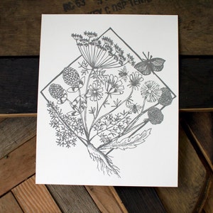 May include: A black and white line drawing of a bouquet of wildflowers, including a butterfly, in a diamond shape on a white background.