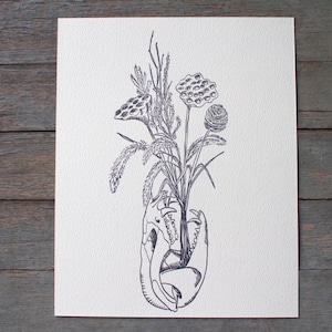 May include: A black and white pen and ink illustration of a floral arrangement. The bouquet features various plants and flowers, emerging from a skull. The artwork is on a white paper background, set against a rustic wooden surface.