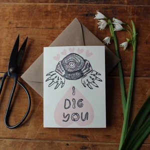 May include: A greeting card with a cartoon mole with pink hearts and the text "I DIG YOU".
