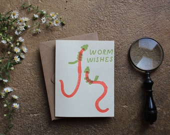 Tarjeta de felicitación con diseño de juego de palabras navideño "Worm Wishes" (tipografía impresa)