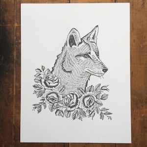 May include: Black and white illustration of a fox's head in profile, surrounded by roses and leaves. The artwork is detailed with fine lines, creating a textured effect. The fox's fur and the floral elements are intricately rendered.