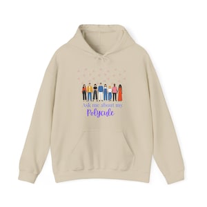 May include: Beige hoodie with a front pocket and drawstring hood. The front features a graphic of diverse figures and the text "Ask me about my Polycule" in purple and the word "Polycule" in a script font.