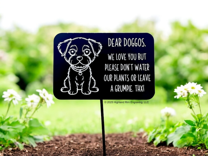 May include: A black garden sign featuring a cartoon dog illustration and the text "DEAR DOGGOS. WE LOVE YOU BUT PLEASE DON'T WATER OUR PLANTS OR LEAVE A GRUMPIE. THXI". The sign is placed in a garden, among plants.