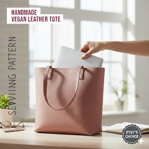 May include: A dusty rose vegan leather tote bag with handles. A hand is placing a laptop inside the bag. Text on the image reads "HANDMADE VEGAN LEATHER TOTE" and "SEWIINNG PATTERN". The Etsy's Choice badge is visible.