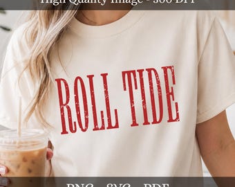 May include: A cream-colored short-sleeve t-shirt featuring the text ROLL TIDE printed in a distressed red font across the chest. The shirt has a crew neckline and a standard fit, showcasing a clear and legible graphic design for digital use.