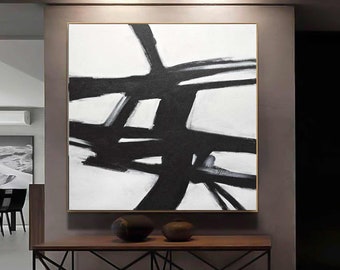 May include: Abstract black and white painting with bold brushstrokes on a white canvas. The painting features a series of intersecting lines and shapes, creating a dynamic and modern design.